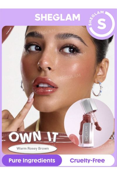 درخشندگی کریستالی روی لب رایحه‌ی شیرینی‌های موردعلاقه رنگ نچرال روی لب آبرسانی عمیق لب تسکین لب و… شیگلم SHEGLAM برق لب شیشه‌ای ایر گلاس 312 OWN IT